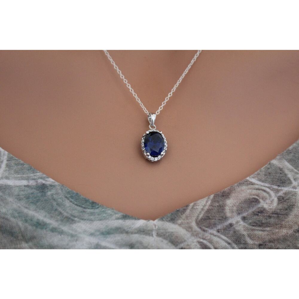 Sterling Silver Blue Oval CZ Pendant Circled in Clear CZ Stones Necklace